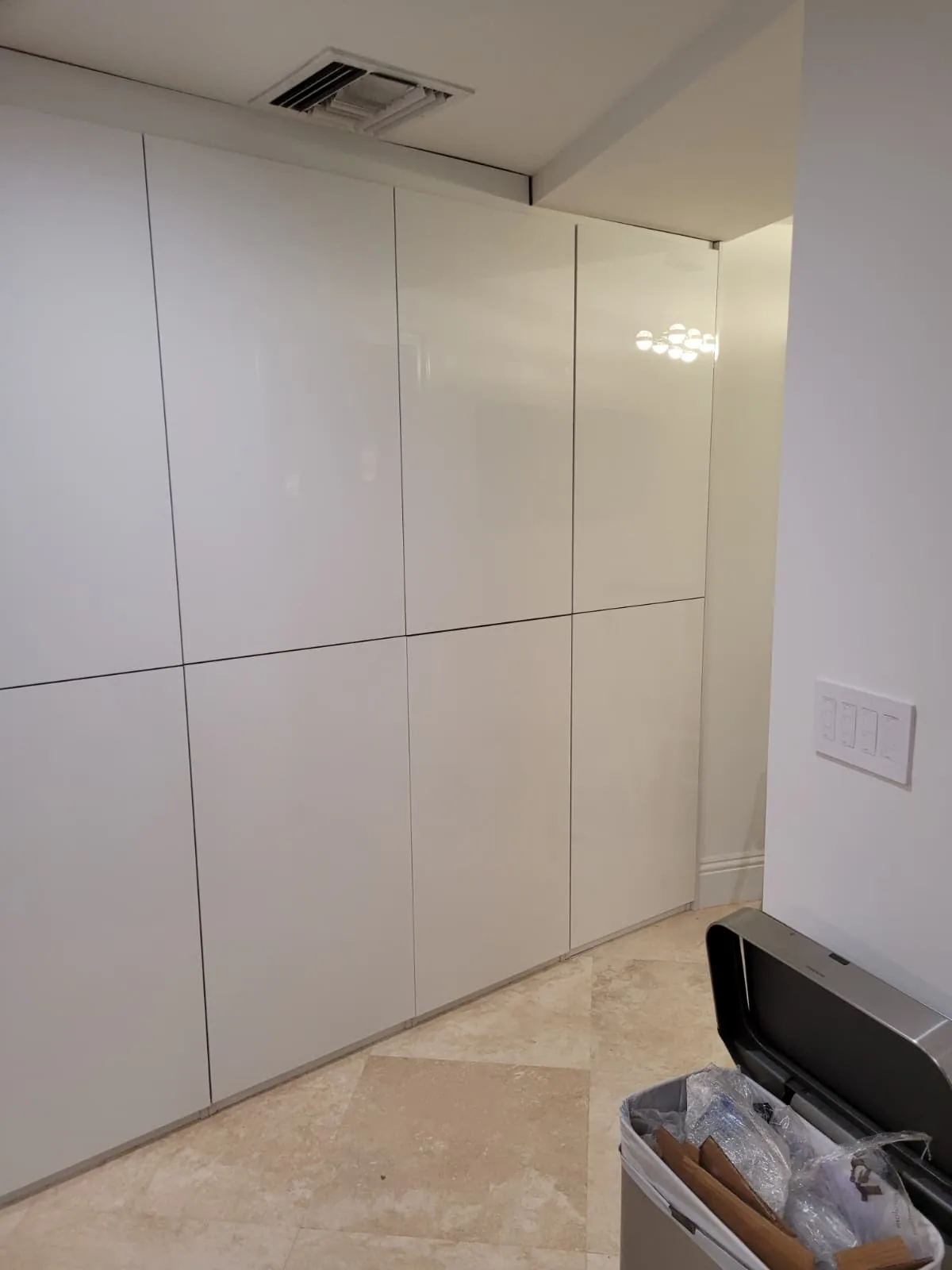 Floor-to-ceiling white gloss cabinet wall
