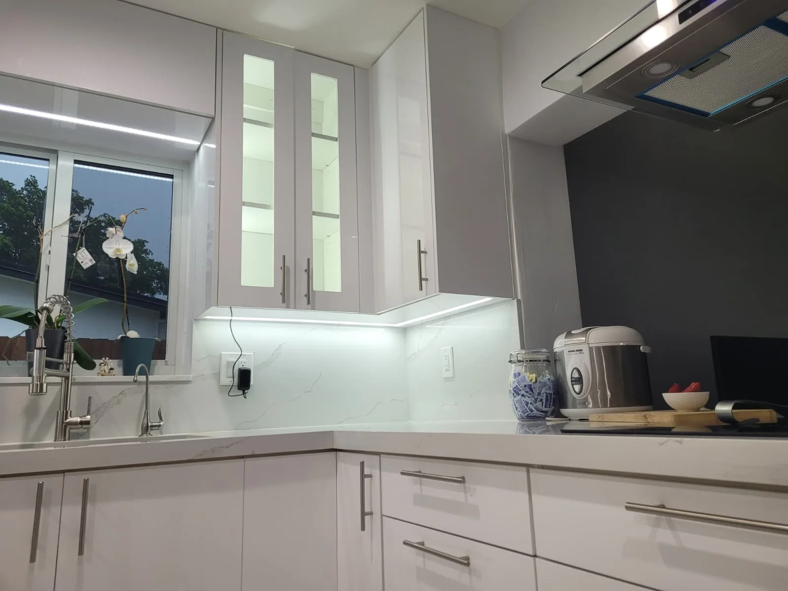 Kitchen with glass upper cabinets and LED lighting