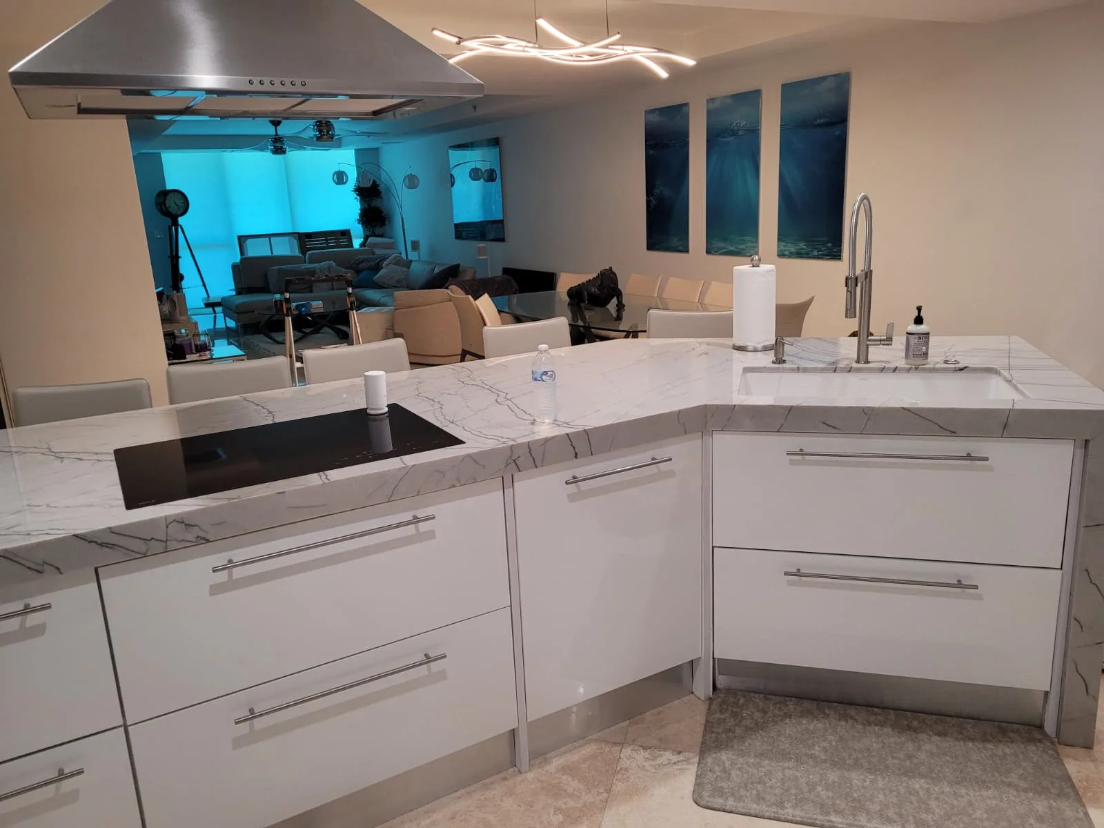 Custom white kitchen with marble-look island and sink