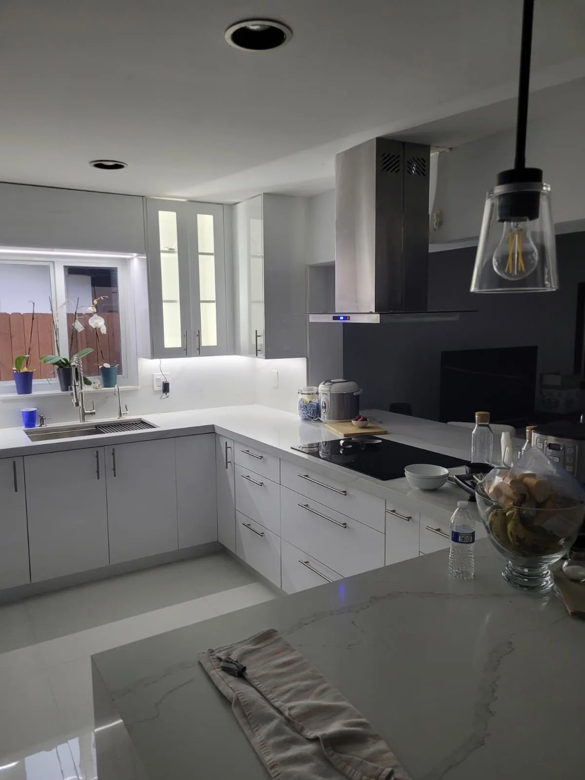 Waterfall island kitchen with pendant lighting