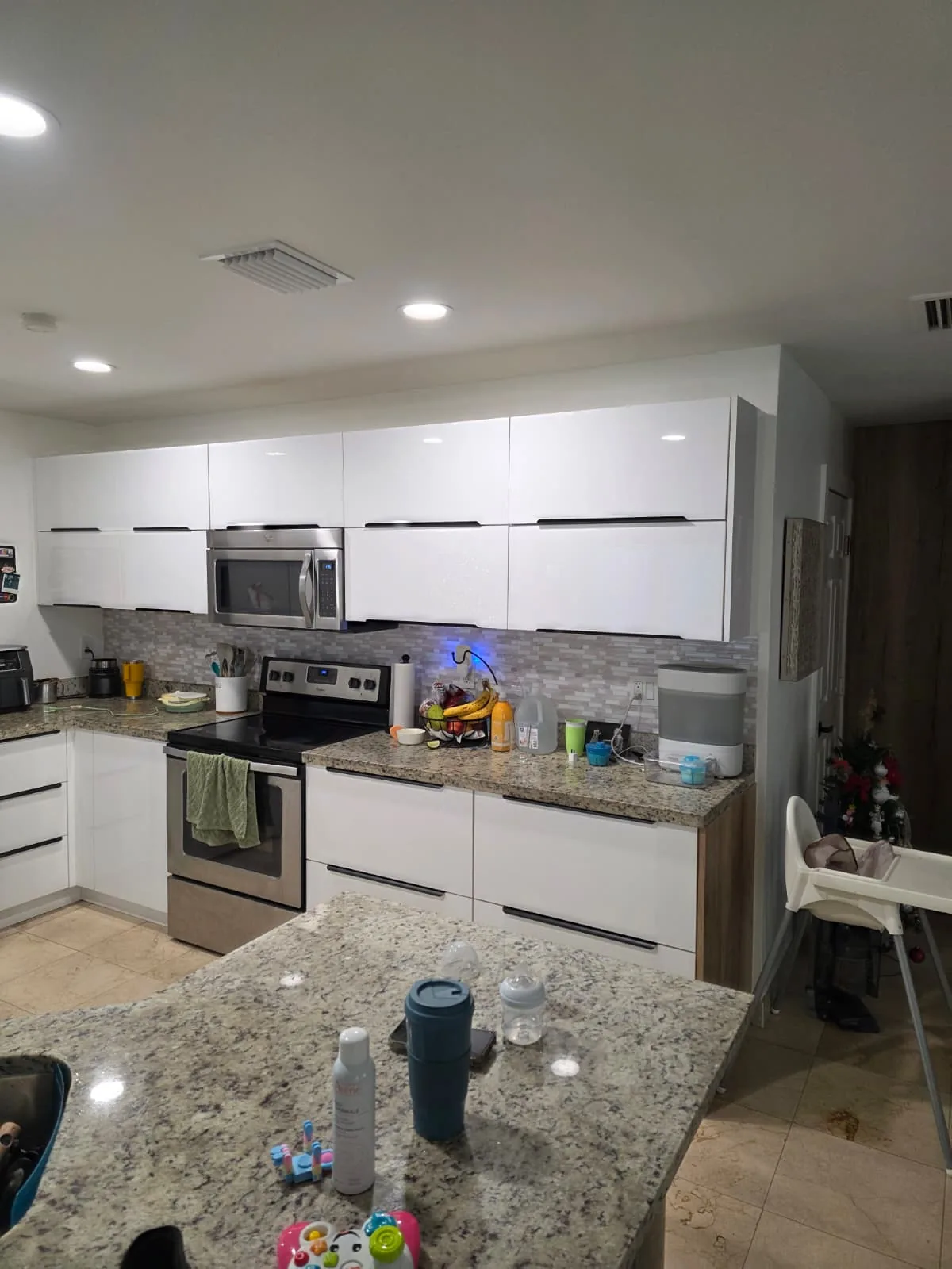 Two-tone kitchen with granite counters and white fronts
