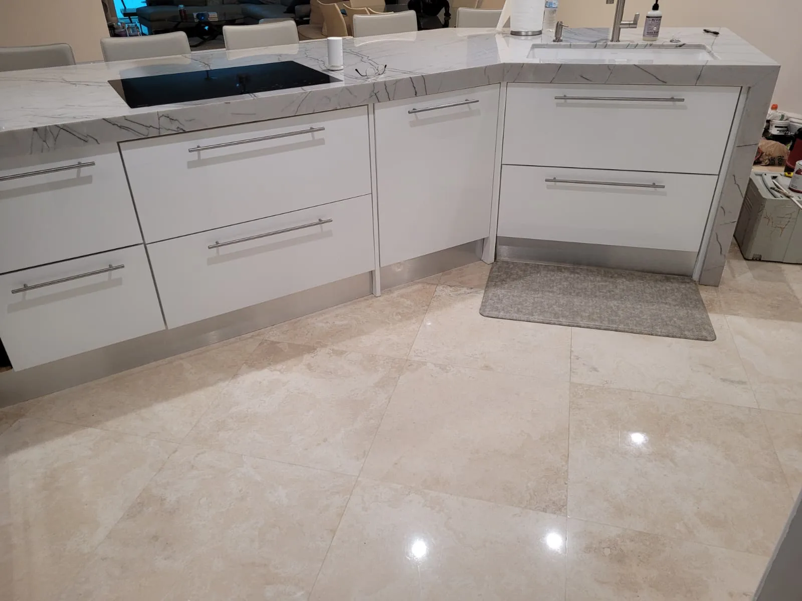 White kitchen with marble waterfall counter by the window