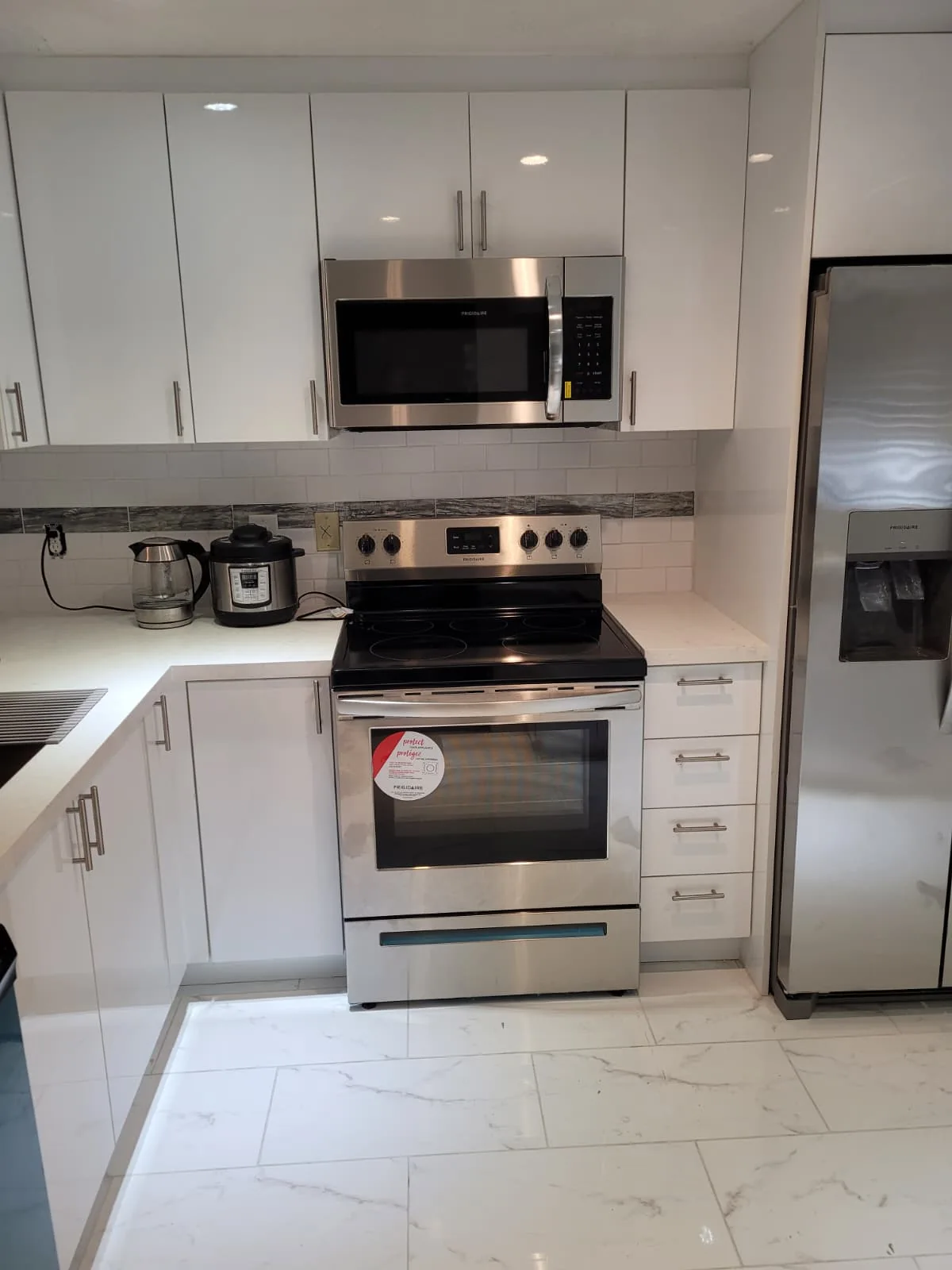 White shaker kitchen with stainless appliances