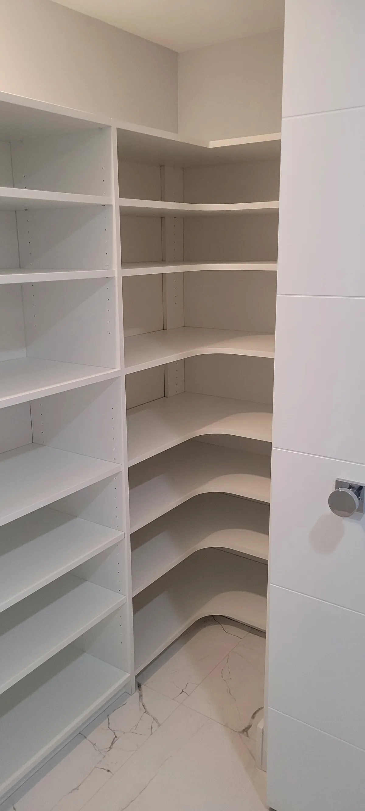 Corner pantry with wrap-around shelving