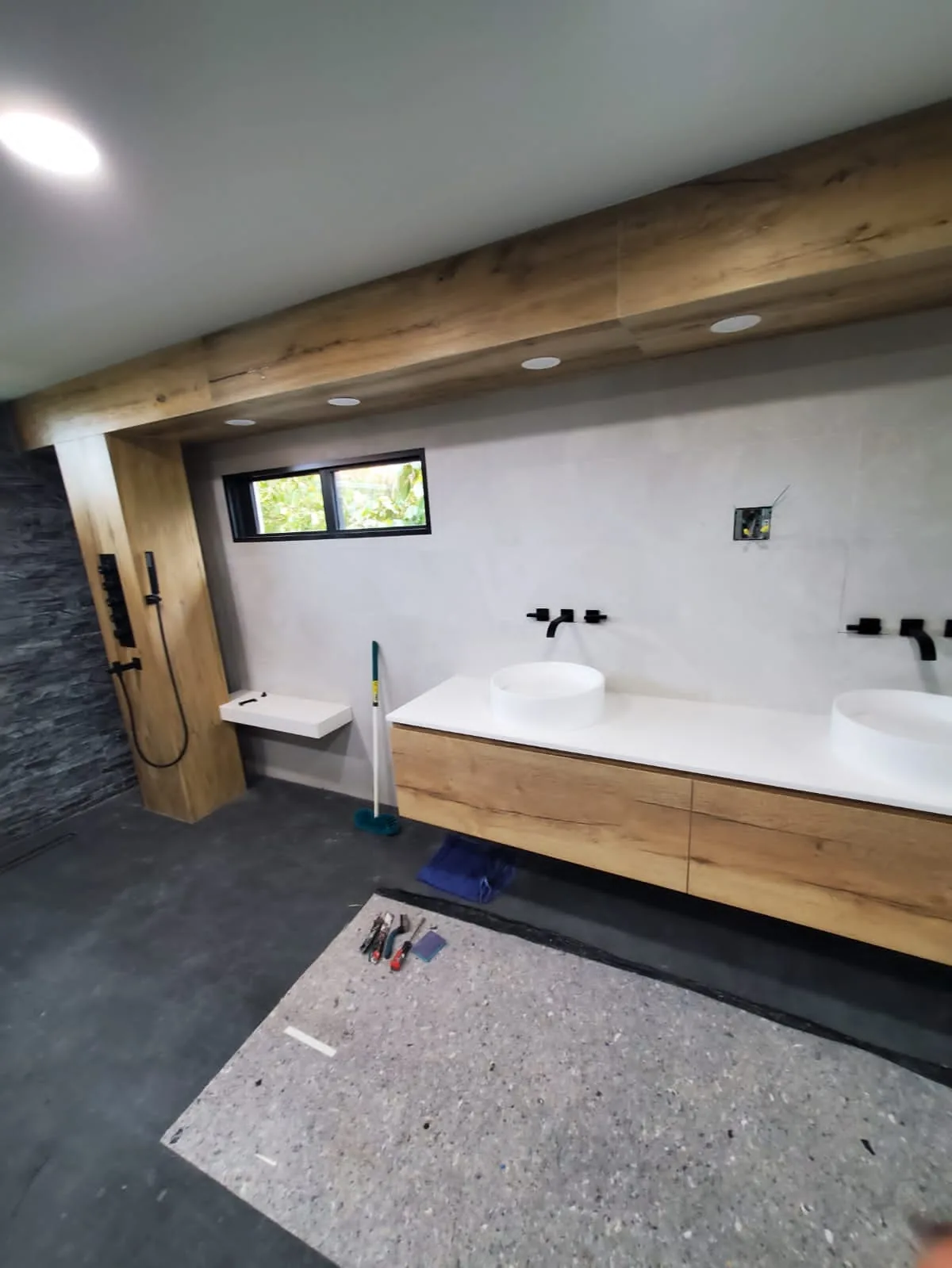 Floating oak double vanity with round vessel sinks
